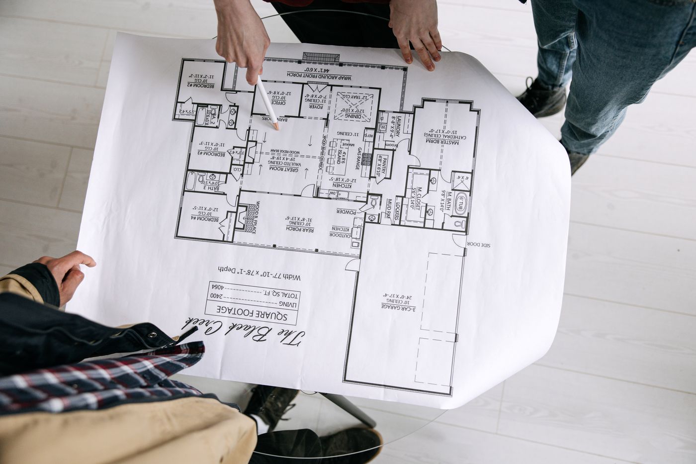 Overhead view of two people reviewing a residential floor plan